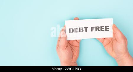 Debt free in process, ending credit payments and bank loans, financial freedom, message on paper Stock Photo