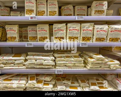 Italy - January 26, 2024: Pasta Rummo in recyclable paper package of various types and formats displayed on shelves for sale in an Italian supermarket Stock Photo