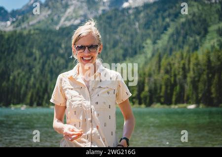 Woman Smiling In Front Of The Teton Mountain Range Across String Lake 