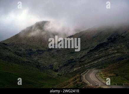 winding road in gloomy foggy rocky mountains. Dark Pass in the Karatau mountains in Southern Kazakhstan Stock Photo