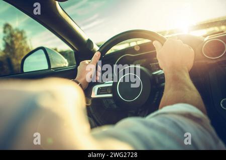 Automotive Theme. A Man Behind Modern Car Steering Wheel Stock Photo