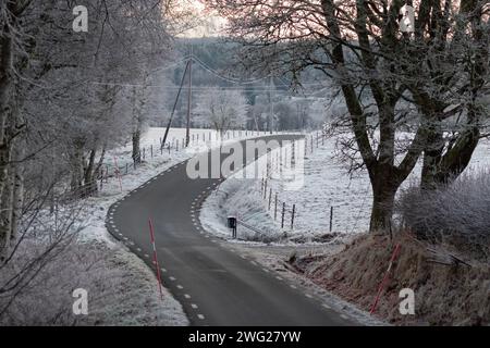 Country road in a frozen rural landscape in Sweden Stock Photo