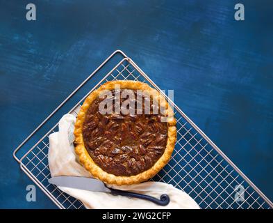 Small pecan pie shot from above on a cooling rack with a guaze linen Stock Photo