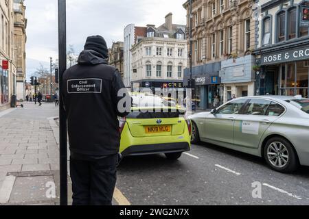 A Civil Enforcement Officer, or traffic warden in the city centre of Newcastle upon Tyne, UK Stock Photo