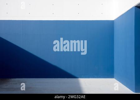 blue and white concrete wall with sunlight and shadows Stock Photo