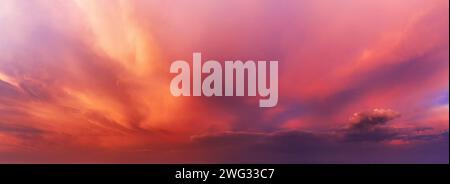 Dramatic sky background with orange and purple clouds at sunset. Stock Photo