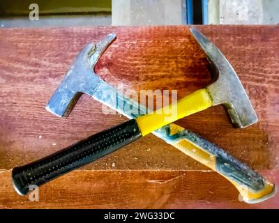 two hammers with an abstract background, as a tool for hammering nails Stock Photo