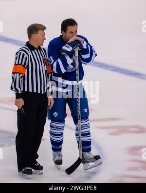 Toronto, Canada - November 13, 2011: Former referee Kerry Fraser talks to Hall of Famer Doug Gilmour during Hockey Hall of Fame Legends Classic game at the Air Canada Centre during induction ceremonies in Toronto. Fraser is known for his handling of the 1993 game six semi-finals, some fans still claim he cost the Maple Leafs a shot at the finals when he did not penalize Wayne Gretzky for high sticking Gilmour. Stock Photo