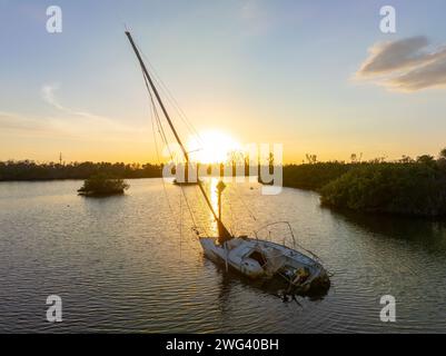 Aerial view of sunken sailboat on shallow bay waters after hurricane in Manasota, Florida Stock Photo