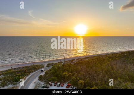 Parking lot at Blind Pass beach on Manasota Key in Englewood. Tourists cars in front of ocean beach with soft white sand in Florida. Popular vacation Stock Photo