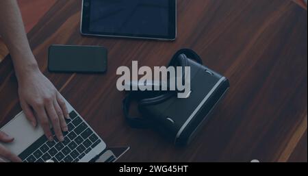 Person working on a laptop in an office setting Stock Photo