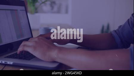 Young African American man typing on a laptop in an office Stock Photo