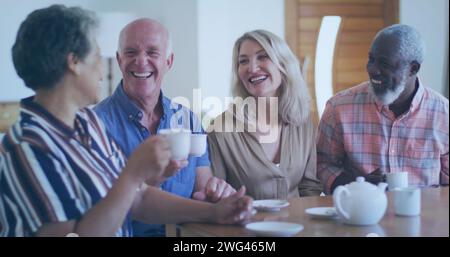 Diverse group of friends share laughter over coffee at home Stock Photo
