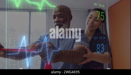 Image of heart data over biracial female doctor with male patient Stock Photo