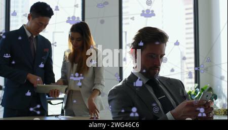 Image of network of digital icons over businesspeople using smartphone and tablet Stock Photo