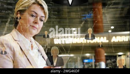 Financial data processing against caucasian senior businesswoman using smartphone at airport Stock Photo