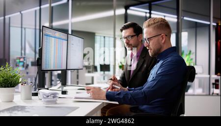 Using Corporate Invoice Spreadsheet On Computer Monitors Stock Photo