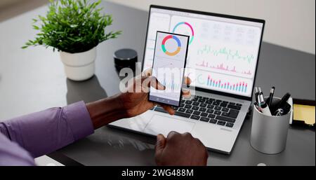 African American Data Analyst Using Data Analytics KPI Dashboard Stock Photo