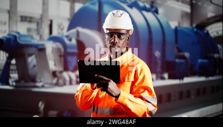 African Engineer Man Checking Industrial Facility. Osha Inspection Stock Photo