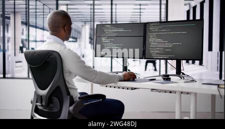 African American Coder Using Computer At Desk. Web Developer Stock Photo