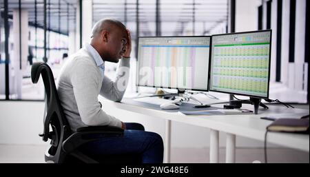 Data Analyst African Man Using Spreadsheet On Computer Stock Photo