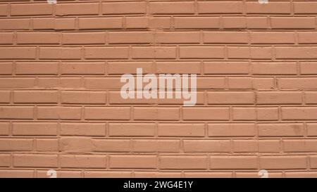 Latte painted brick wall, graphic design resource with an empty copy of the spaces of a pink-brown shade, brickwork as a background texture Stock Photo