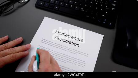 Person Reading HOA Rules And Regulations Document Stock Photo