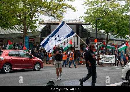 Nelson, New Zealand, 3rd February 2024, A protestor carrying an Israeli flag walks on the opposite side of the pavement to protestors carrying Palesti Stock Photo