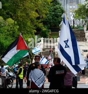 Nelson, New Zealand, 3rd February 2024, Two protestors, one carrying a Palestinian flag, the other with an Israeli flag stand together during protests Stock Photo