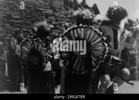 Buffalo dancers, c1905. Costumed dancers wearing dance bustles of Tewa sun god made of turkey feathers. Stock Photo