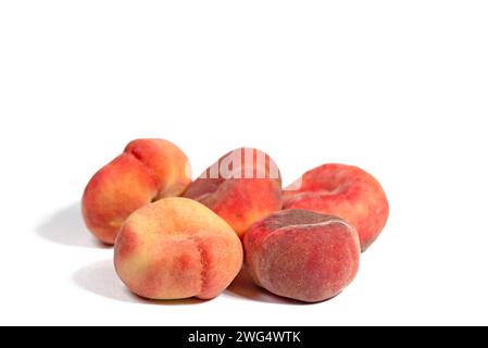 Flat peaches isolated against white background Stock Photo
