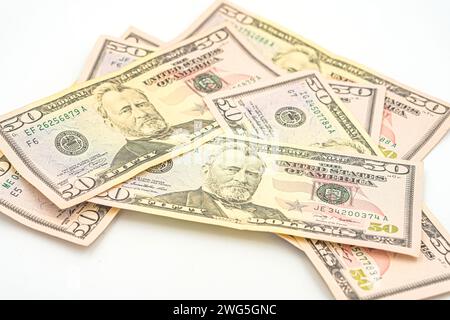 Fifty 50 dollar bills fanned out on a white background. Lots of 50 dollar bills, the concept of American cash. US paper money. Bribery with a wad of m Stock Photo