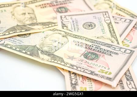 Fifty 50 dollar bills fanned out on a white background. Lots of 50 dollar bills, the concept of American cash. US paper money. Bribery with a wad of m Stock Photo
