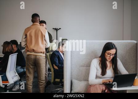 Business coworkers collaborating and discussing reports in a creative office. Stock Photo