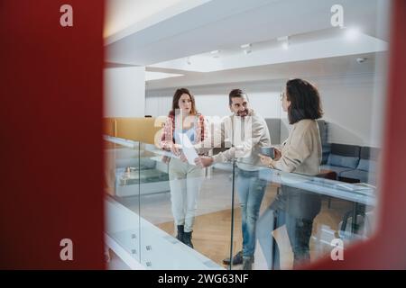 Casual business meeting with colleagues discussing project at modern office. Stock Photo