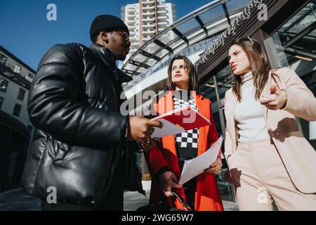 A professional man and woman engage in a friendly discussion outside an office building. Captures a sense of partnership and cooperation. Stock Photo