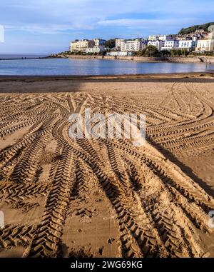 Tyre tracks in the sand on the beach at Weston super Mare's tidal  marine bathing pool Somerset UK Stock Photo