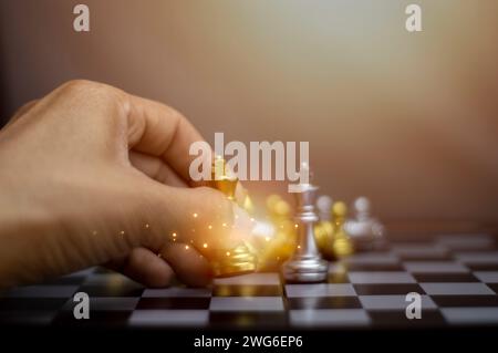 Businessman concept holding gold king chess pieces, silver chess pieces on chessboard for business strategy and leadership delegation concept, leaders Stock Photo