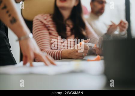 Focused team members collaborating in a business meeting with documents. Stock Photo