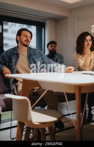 Engaged young professional speaking in a creative office meeting Stock Photo