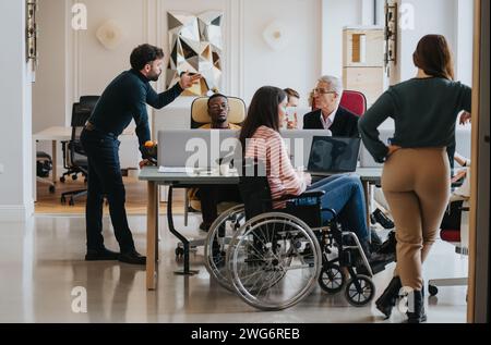 Inclusive office environment showing a diverse team during a business meeting. Stock Photo