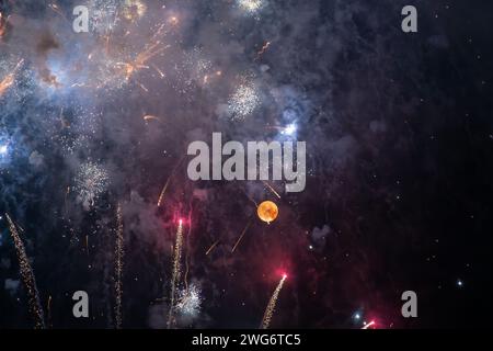 Night sky lit by full moon and fireworks for the Feast of the Madonna of Montallegro, patroness of Rapallo, Genoa, Liguria, Italy Stock Photo