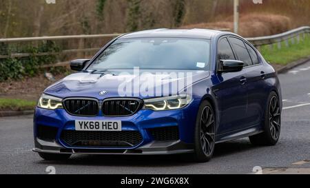 Milton Keynes,UK-Feb 3rd 2024:2019 blue BMW 5 series M5 competition car  driving on an English road. Stock Photo