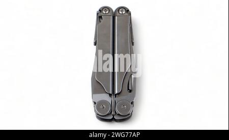 Folded steel multitool isolated on white background, top view. A tool for daily practice. All in one. Construction and repair. Compact and portable pr Stock Photo