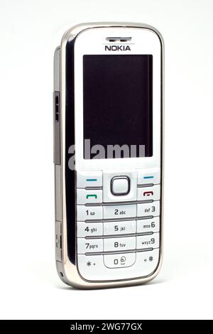 Close up of a Nokia 6233, a candybar style mobile phone from the early 2000s, shot against a white background. Stock Photo