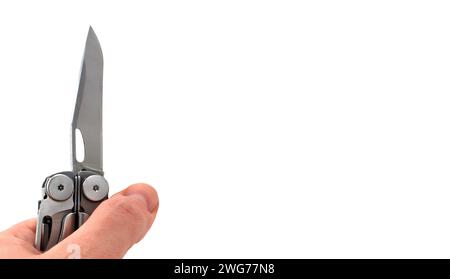 On a white background, a man's hand holds a steel multi-tool with an open knife blade. Pocket open folding knife. Portable multitasking multitool with Stock Photo