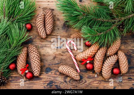 Cones and fir branches on wooden background. Stock Photo