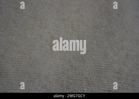 Light soft fabric with a fine weave texture, beige and cream fleecy background. Stock Photo