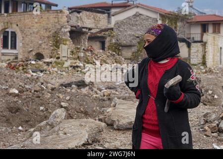 Hatay, Turkey. 03rd Feb, 2024. Mehmet's sister Ayla poses for a photo with a hammer. Turkey experienced the largest earthquake in its history on December 6, 2023, in the border region of Syria. Following the consecutive 7.4 and 7.7 earthquakes, 10 cities in the eastern region were affected. There are still ruins of collapsed buildings in the city center of Hatay, one of the most affected cities. (Photo by Tunahan Turhan/SOPA Images/Sipa USA) Credit: Sipa USA/Alamy Live News Stock Photo