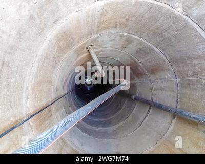 Well view from the inside. View from inside vertical tube downcast shaft Stock Photo
